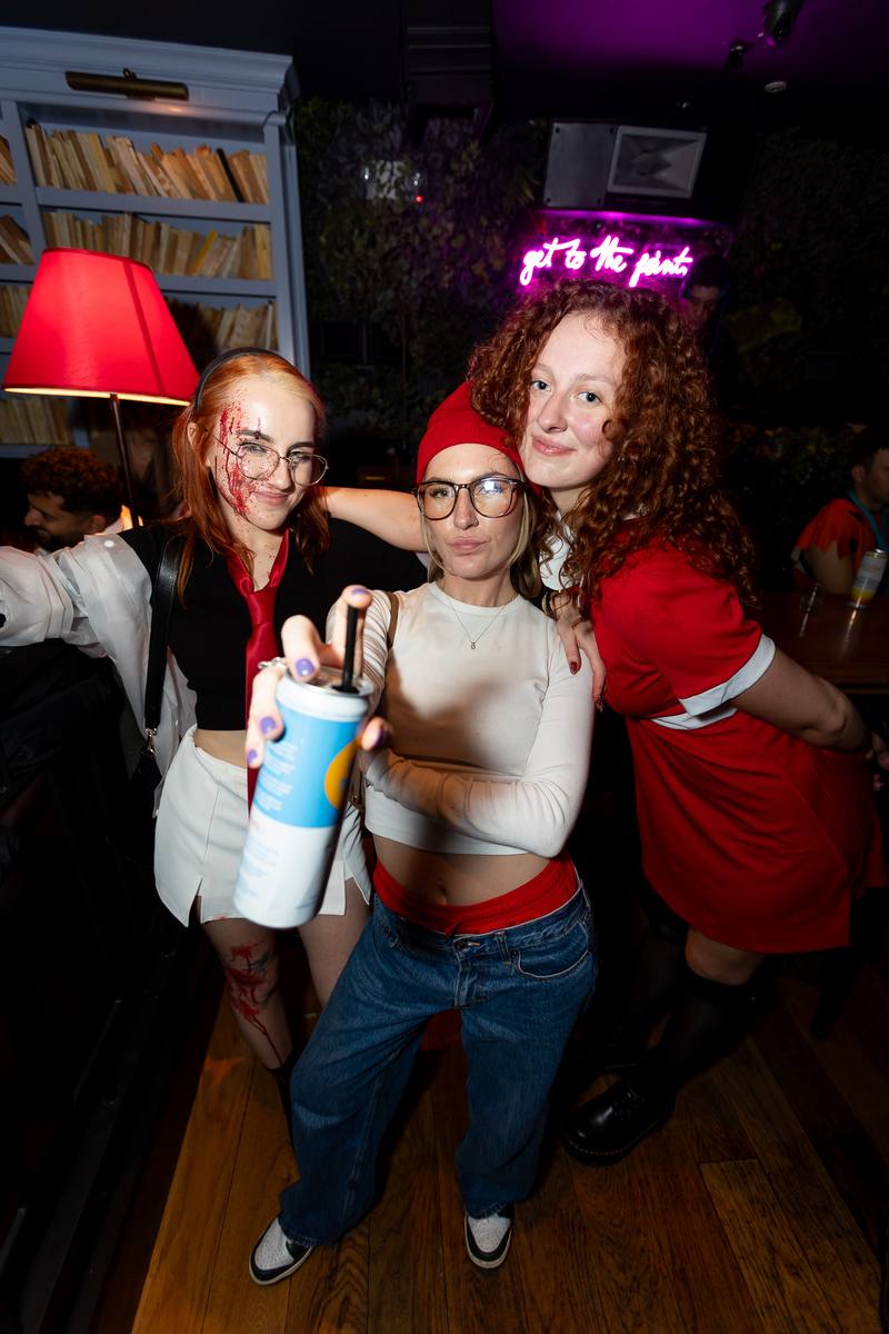 A costumed group celebrating together at a Crawlloween venue